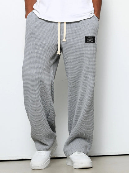 Men's Waffle-Textured Drawstring Trousers with Side Pockets and Wide Legs for Casual Wear